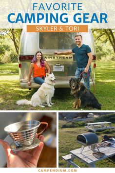 a man and woman standing in front of a camper with their dog on leashes