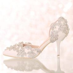 a pair of white wedding shoes with crystal embellishments