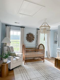 a baby's room with a crib, rocking chair, and large window