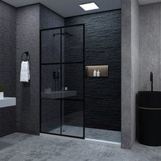 a black and white bathroom with a shower, sink, mirror and towel on the wall