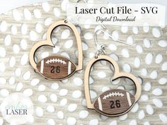 two wooden heart shaped earrings with numbers and footballs on them, one is laser cut