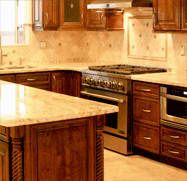 a large kitchen with wooden cabinets and marble counter tops