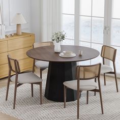 a dining table with four chairs around it