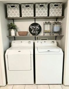 a washer and dryer in a laundry room with baskets on the shelves above them