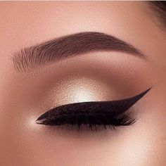 an eyeliner with long black lashes and gold eyeshadow is shown in this close up photo