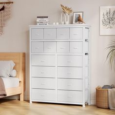 a bedroom with a white dresser and bed