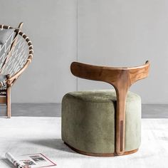 a green chair sitting on top of a white rug