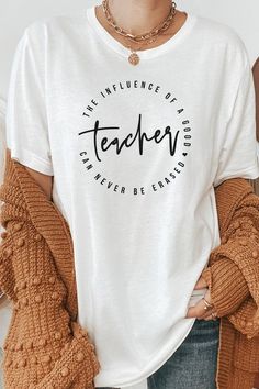 Introducing "The Influence Of A Good Teacher Can Never Be Erased" Heart Graphic Tee from Kissed Apparel. Elevate your merchandise with this impactful and meaningful design. Most t shirt colors are 52/48 cotton/poly blend. White and Cream tees are 100% cotton, Ash tees are 99/1 cotton/poly. Perfect for celebrating the lasting impact of teachers. Order now to enhance your back to school line and captivate customers with this inspiring and heartfelt tee.Made In: USAFabric Contents: Most t-shirt col Inspirational Cotton Tops With Quote Print, Cotton Crew Neck Shirt With Quote Print, Crew Neck Cotton Shirt With Quote Print, Inspirational Quote Print Cotton Top, Inspirational Cotton Slogan Shirt, Crew Neck Slogan Shirt For Teacher Appreciation, Casual Cotton T-shirt In Heather Peach, Heather Peach Short Sleeve Graphic Tee, Casual Peach T-shirt With Graphic Print