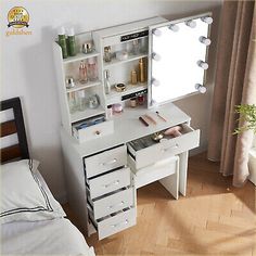 a white vanity with drawers and lights on it