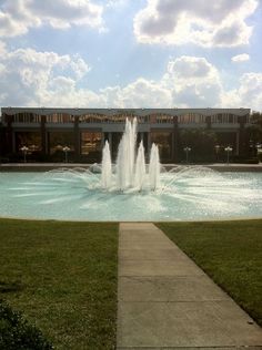 a large water fountain in front of a building