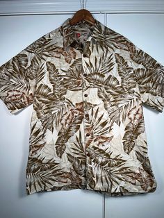 Hilo Hattie The Hawaiian Original Vintage Shirt. Short sleeve button down. One of the more collectible brands. Cool looking. Nice! Made in Hawaii USA Size Large (L) Mens 100% Cotton No odors, no damage, clean. Vintage Hilo Hattie!  Please message me with any questions or for size measurements. Packed and shipped with quality materials. Casual Camp Shirt With Vintage Print, Casual Collared Camp Shirt With Vintage Print, Classic Relaxed Fit Hawaiian Cotton Shirt, Classic Relaxed Fit Cotton Hawaiian Shirt, Casual Shirt With Vintage Print And Camp Collar, Casual Shirt With Camp Collar And Vintage Print, Casual Button-up Shirt With Vintage Print, Hawaiian Cotton Shirt With Buttons, Brown Cotton Hawaiian Shirt With Short Sleeves