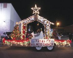 a parade float decorated with christmas lights and decorations