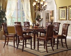 a dining room table with chairs and a chandelier