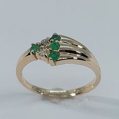 This stunning Emerald and Diamond Ring has been carefully crafted in warm 10K Yellow Gold , Authentic Emerald and Diamonds. Great for any occasion! Buy it for your-self or buy it for someone you love! Ring Weight and Stones Measurements: Ring weights 2.1 grams. Material: 10K Yellow Gold , Emeralds and Diamonds Emerald Measurements: 4 Emerald 2.25 mm (Color: Green) Diamonds: 2 Diamond 0.03 Total: 0.06 Ct Ring Size: 6 1/2 All of my jewelry is handmade from scratch and of high quality. Ring can be 14k Gold Green Rings With Accent Stones, Green 14k Gold Rings For Anniversary, Green 14k Gold Ring With Accent Stones, Green 14k Gold Rings With Accent Stones, Fine Jewelry Rings Hallmarked For May Birthstone, Fine Jewelry Hallmarked May Birthstone Rings, 14k Gold Hallmarked Ring For May Birthstone, Green 14k Gold Cluster Ring For Anniversary, Green Diamond Ring In 14k Gold For Anniversary