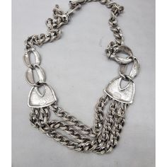 Rhodium plated chain bib necklace with three chains in the front which are gathered at the sides necklace with fold over clasp. Marked "Napier" in script. Measures: 9 inches long by 6 inches wide. Center drop: 1 1/4 inches long. Interior circumference is about 21 1/2 inches.  Excellent condition. This is from Napier's 1990 Neo-Classics line. An identical necklace is shown on pg. 663 of Melinda L. Lewis & Henry Swen's book "The Napier Co.: Defining 20th Century American Costume Jewelry." Silver Bib Necklace With Chain In Costume Jewelry Style, Silver Bib Necklace With Chain For Costume Jewelry, Silver Multi-strand Chunky Chain Necklace, Silver Chain Bib Necklace For Costume Jewelry, Silver Chunky Multi-strand Necklace, Silver Metal Bib Necklace For Formal Occasions, Elegant Silver Bib Necklace With Adjustable Chain, Vintage Metal Chain Necklace With Oxidized Finish, Silver Chain Link Necklace With Oxidized Finish