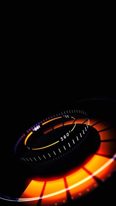 an orange and black circular object in the dark