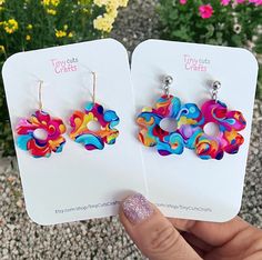 Colorful Groovy Flower Earrings. Crafted from high-quality patterned acrylic, these earrings are wonderfully lightweight. Choose from two sizes: Small, with a 1" diameter flower, or Large, with a 1.25" diameter flower. Designed for comfort, these earrings feature hypoallergenic stainless steel findings, making them gentle on even the most sensitive ears. Their lightweight construction ensures you can wear them joyfully throughout the day, effortlessly adding a touch of flair to any outfit withou Multicolor Summer Flower Charm Earrings, Summer Multicolor Flower Charm Earrings, Trendy Summer Flower Charm Earrings, Multicolor Floral Print Flower Earrings, Playful Multicolor Flower Earrings As Gift, Summer Multicolor Earrings With Flower Charm, Colorful Earrings As Spring Gift, Colorful Spring Gift Earrings, Colorful Spring Earrings For Gift