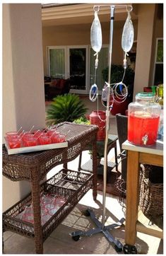 a table that has some drinks on it and an umbrella in the middle of it