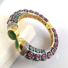 This Listing is for 1 Piece Beautiful Red Aventurine,Green Onyx & CZ Hydro Gemstone 24k Gold Plated Cuff Bangle Bracelet Jewelry Gemstone: Red Aventurine,Green Onyx & CZ Metal : Brass Style : Cuff Bracelet Size : Cuff Adjustable Size Plating : 24k Gold Plated & Black Oxidize Color : Green,Yellow,White,Red Note : We Ship Parcel Via India Post Economy Shipping It's Take 20 To 25 Days To Arrive. Check my other items frequently. I will be adding to the inventory regularly. Be sure to vis Multicolor Stone Bangle For Gift, Multicolor Stone Bangle As Gift, Festive Multicolor Gemstone Bracelets, Festive Gemstone Bangle Bracelets, Multicolor Stone Set Bangle Bracelets, Multicolor Stone Setting Bangle Bracelet, Jeweled Round Bangle As Gift, Red Jeweled Bangle As A Gift, Red Jeweled Bangle For Gift