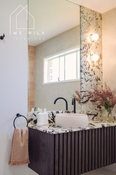 a bathroom with two sinks and a large mirror