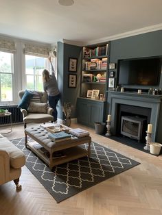 a woman standing in the middle of a living room