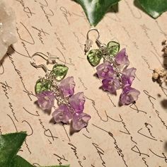 💖 High quality purple wisteria flower glass beaded earrings presented on 925 sterling silver earring hooks with hypoallergenic silicone backs. ️ Measurements:  Flower bead: 8x10mm Leaf bead: 9x9mm Drop length: 35mm Earring hook: 15mm Total length: 50mm Weight: 4g per earring ✨️Metal Information 925 sterling silver hooks (92.5% silver alloy) 🌿 Metal Allergies? I have a range of other metal and non metal options (including clip ons) These can added to your order from my "add on" section in my sh Wisteria Earrings, Fairycore Earrings, Fairy Jewellery, Wisteria Flower, Fancy Decor, Purple Wisteria, Cute Surprises, Fairy Jewelry, Floral Jewelry