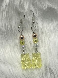 Each earring measures approximately 2 1/2" in length. Brighten up your day with our playful Beaded Yellow Gummy Bear Dangle Earrings. These whimsical earrings feature adorable gummy bear charms, meticulously crafted with a vibrant yellow hue that adds a pop of fun to any ensemble.  The earrings are designed with hypoallergenic hooks, ensuring comfortable wear. The lightweight design allows for easy, all-day wear, making them perfect for adding a touch of joy to your everyday look or for a fun night out. Whether you're a fan of candy-inspired accessories or just looking to add a bit of whimsy to your jewelry collection, these Beaded Yellow Gummy Bear Dangle Earrings are a delightful choice. Embrace your playful side and let these charming earrings bring a smile to your face and a sparkle to Gummy Bears Earrings, Bear Beaded Earrings, Gummy Bear Charms, Whimsical Earrings, Gummy Bear Earrings, Bear Earrings, Earrings Rose Gold, Earring Making, Gummy Bear