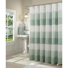 a green and white shower curtain in a bathroom