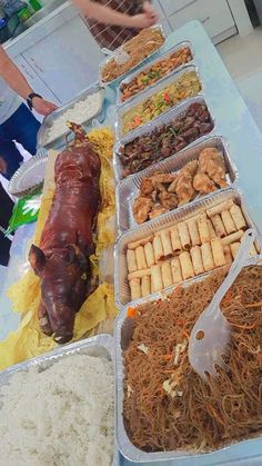 several trays filled with food on top of a table