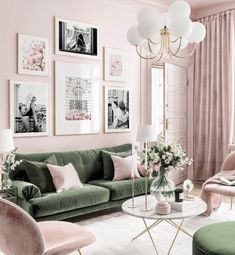 a living room with pink walls and green couches, white rugs and pictures on the wall