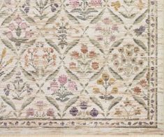 an old rug with flowers and leaves on the bottom, in beige tones is shown