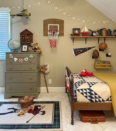 a bedroom with a bed, dresser and basketball hoop