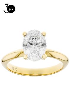 a yellow gold engagement ring with an oval cut diamond in the center and two clawed shoulders