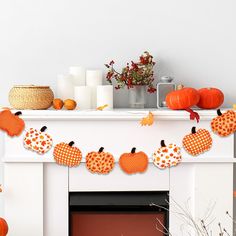 a decorated mantle with pumpkins and candles