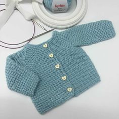 a blue sweater and white headphones are on display