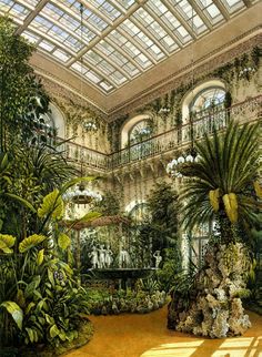 the inside of a large building with lots of plants and trees in it's center