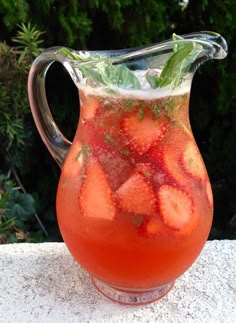 a pitcher filled with liquid sitting on top of a table