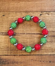 "This listing is for one bracelet. Choose either gold or silver spacer beads.  This is a beautiful red and lime green Shamballa bracelet. It is just gorgeous! If you like bling, this bracelet has it. It is made from clay and rhinestone shamballa beads with gold (brass) or silver (stainless steel) accent beads.  It is elastic for the perfect fit and easy to put on. It is 7\" long. This is a bracelet you will love to wear!" Holiday Beaded Jewelry, Christmas Jewelry Ideas, Winter Bracelet, Holiday Beading, Green Bracelet, Diy Jewelry Inspiration, Bubble Necklaces, Christmas Bead, Diy Bracelet Designs