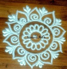 an intricate white doily on a wooden surface