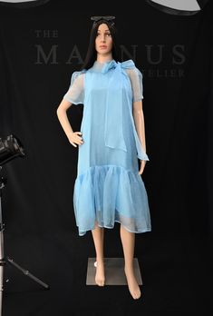 Step into effortless elegance with our Women's Blue Organza Midi Dress. This stunning organza dress captures the essence of summer fashion, perfect for special occasions or casual outings. Key Features: - Luxurious blue organza fabric for a delicate look - Flattering midi length that suits all body types - Lightweight and breathable, ideal for warm weather - Available in sizes XS to XL with customization options Crafted with care, this dress is not just a stylish choice; it's a sustainable one t Summer Party Chiffon Dress With Short Sleeves, Blue Sheer Midi Dress For Party, Silk Chiffon Summer Dress, Blue Sheer Silk Dress, Sheer Organza Short Sleeve Dress, Sheer Organza Dress With Short Sleeves, Sheer Chiffon Evening Dress For Summer, Sheer Chiffon Summer Evening Dress, Sheer Chiffon Dress For Summer Evenings