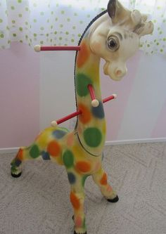 a toy giraffe is standing on its hind legs with a stick in it's mouth