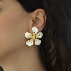 The magnolia flower meaning is attached with the symbols of nobility, perseverance, and love of nature. Soft and subtle in color yet strong in appearance, the flower is representative of the beauty encompassing femininity and gentleness. These earrings are handmade with 22K gold plated brass and enamel. These nickel free earrings are for pierced ears. They come as a pair with both butterfly and silicone earring backs. These beautiful earrings come with the Milou Jewelry box For avoiding damage t Elegant Blossom Flower Pendant Jewelry, Elegant Blossom Color Flower Pendant Jewelry, Elegant Spring Petal Shaped Flower Earrings, Elegant Spring Earrings For Anniversary, Elegant White Flower Earrings, Elegant Flower Jewelry For Spring, Elegant Birth Flower Earrings, Elegant White Flower Jewelry, Elegant White Jewelry For Spring