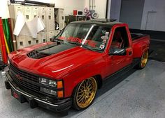 a red pick up truck parked in a garage