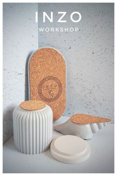 an advertisement for the inzo workshop, featuring two white vases and one round object