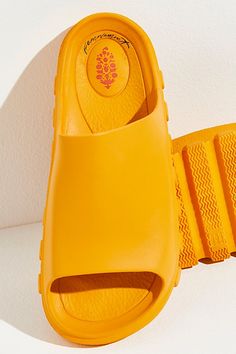 A pre- and post-workout essential, these sporty slides are featured in a smooth fabrication and slip-on style with a dreamy, cushioned insole, a single wide strap, and bold traction details perfect for taking you from the studio to the street. * Buti logo detailing * Flat-sole style * Lightweight design **Sizing:** * S: EU 35/36, US 5/6 * M: EU 37/38, US 7/8 * L: EU 39/40, US 9/10 * XL: EU 41/42, US 11/12 **Fit:** This style runs true to size; if in between sizes, we suggest sizing up. **About T Spring Foam Slip-on Slides, Comfortable Solid Color Slides With Rubber Sole, Foam Slide Sandals With Rubber Sole, Foam Slides With Rubber Sole, Summer Slides With Rubber Sole And Foam, Slip-on Slip-resistant Foam Slides, Slip-resistant Foam Slip-on Slides, Casual Foam Slides With Rubber Sole, Sporty Foam Slides With Round Toe