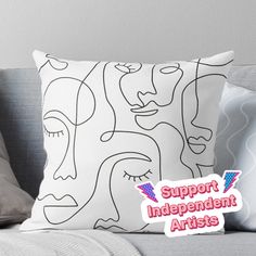 a black and white pillow with the words support independent artists in pink lettering on it