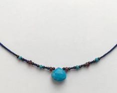 ❘❘❙❙❚❚ ON SALE ❚❚❙❙❘❘ This is a very fine delicate semi precious necklace made with Turquoise teardrop stone, Lapis lazuli beads and touch of faceted 3mm Garnet, oxidised silver and Turquoise beads.Turquoise teardrop is 10x10mm size.Please take a look at all the photos and ask any questions you might have.The necklace is short but not quite a choker - it sits just under the collar bones.The full measurement from clasp to end is 44cm or 17.5 inches.All the jewellery comes in Heiter branded boxes. Adjustable Teardrop Turquoise Necklace With Natural Stones, Turquoise Pendant Necklace With Faceted Beads, Turquoise Teardrop Faceted Beads Jewelry, Artisan Teardrop Gemstone Beaded Necklace, Adjustable Teardrop Turquoise Necklace, Handmade Turquoise Drop Necklaces, Bohemian Faceted Turquoise Beaded Necklaces, Handmade Turquoise Drop Necklace, Turquoise Briolette Gemstone Bead Necklaces