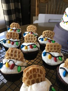 some cupcakes with white frosting and decorations on them