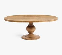 a round wooden table with four leaves on the top and one leaf at the base