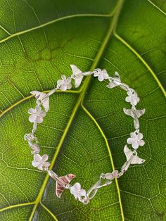 "8MM WHALE TALE PLUMERIA STERLING SILVER BRACELET This genuine 925 sterling silver bracelet features the plumeria flower. Plumeria, in Hawaiian culture symbolizes beauty, charm, grace, and new beginnings, or re-birth. It is one of the most popular flowers on the Hawaiian Islands and widely used in lei making and jewelry designs. Makes a great gift or addition to your Hawaiian jewelry collection. Material: 925 STERLING SILVER Length available: 7\" or 7.5\" Diameter of Flower: 6mm Closure: Lobster Delicate Sterling Silver Flower Bracelets, Delicate Sterling Silver Flower Bracelet, Delicate Flower-shaped Sterling Silver Bracelets, White Sterling Silver Flower Bracelet, White Sterling Silver Flower Bracelets, White Flower-shaped Sterling Silver Bracelets, White Flower-shaped Sterling Silver Bracelet, Flower Plumeria, Lei Making